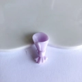Detailed macro view of purple resin mini bouquet charm with a delicate bow for DIY crafts - Purple