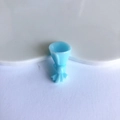 Close-up of light blue resin flower bouquet charm with bow knot for DIY accessories - Blue