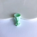 Detailed view of a mint green resin mini flower bouquet charm for DIY jewelry design - Green