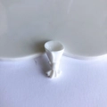 Macro detail of white resin floral bouquet charm for DIY jewelry and crafts making - White