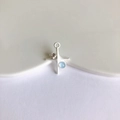 Detailed macro view of a matte silver star cross pendant with blue zircon for DIY jewelry - Matte Silver with Blue