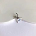 Detail of star-shaped silver pendant with light blue gemstone and sparkling zircon accent - Silver & Blue