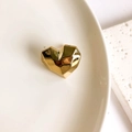 Detail of a vintage-style gold heart earring showing a polished geometric mirrored finish - Gold Heart