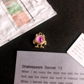 Detail shot of golden monster eye pendant with pink stone on vintage black background - Dark Pink Eye Gold Base