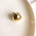 Macro detail of gold irregular textured stud earrings with a crumpled metal finish - Small Golden Heart