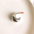 Detailed close-up of chunky silver C-shape earrings with high-polish metallic finish - Silver Fat Crescent