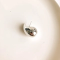 Close-up of a silver waterdrop earring with a mirror-polished finish on a white tray - Silver Teardrop