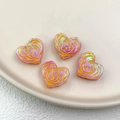 Macro detail of heart-shaped resin beads with golden rose patterns and AB coating - Colorful Pink