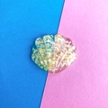 Detailed close-up of shell-shaped resin charm with glitter on a pink and blue background - 1# Yellow Coarse Glitter Seashell