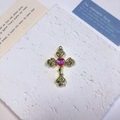 Macro shot of vintage gold alloy cross pendant with pink heart stone and rose motifs - Rose Heart Cross / Light Pink + Gold