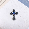 Macro detail of Gothic rose cross pendant with heart-shaped gemstone on stone stand - Rose Heart Cross / Blue Purple + Gun Black