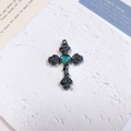 Macro detail of gothic cross pendant with rose relief and heart-shaped opal stone - Rose Heart Cross / Lake Blue + Gun Black