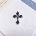 Detailed macro shot of gothic cross pendant with rose relief and rainbow heart stone - Rose Heart Cross / Orange + Gun Black