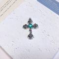 Detailed macro view of vintage silver cross pendant with heart stone and rose details - Rose Heart Cross / Lake Blue + White K