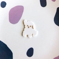 Detailed macro view of white acrylic puppy DIY accessory with gold facial details - White Puppy