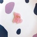 Close-up of a cute translucent pink bear acrylic accessory with fine gold detailing - Pink Marble Dog