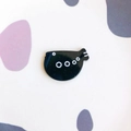 Detailed close-up of a black fish-shaped enamel charm with white circle patterns - Black Small Fish