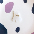 Macro view of cute cream puppy acrylic accessory with pearlescent finish for DIY - White Marble Dog