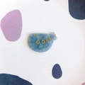 Detail view of fish-shaped acrylic accessory with blue marble texture and gold accents - Blue Marble Fish