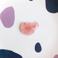 Macro shot of pink marble acrylic fish accessory with golden dots and cartoon design - Pink Marble Fish