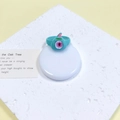 Speelse blauwgroene monsterring met uniek eenogig ontwerp en roze hoorns op een witte voet - Teal Eenogig Roze Hoorn (33#)