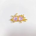Detail of gold alloy heart pendant featuring pink crystals and fluid metal design - Light Pink Matte Gold Heart
