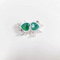Detailed view of dual green heart crystals in a silver liquid metal alloy pendant - Dark Green Matte Silver Heart