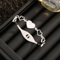 Silberner Stahlarmreif mit weißem Muschelherz, hohlen Herzen und Kristallen - 2269 Hohlherz Weiße Muschel Armband / Stahlfarben