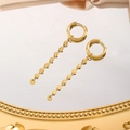 Detailed view of gold plated drop earrings with engraved metal discs on reflective surface - Radiating Cut Ear Lines (5635) / Gold