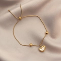 French style gold heart pendant bracelet with shell inlay on champagne silk background - Gold