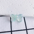 Macro shot of iridescent resin butterfly charm with glitter detail on grid fabric - Aurora Iridescent Glitter (4#)