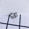 Macro detail of a silver bow pendant with heart-shaped zircon stones and a circular ring - Clear Heart Silver Base (12#)