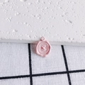 Macro shot of a pink button-shaped alloy pendant with a wax seal inspired design and top ring - Pink Button Wax Seal Style (1#)