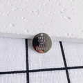 Close-up of polished metal pendant with Keep Calm and Kill Zombies stamped text engraving - KEEP CALM Engraved Round Charm (5#)