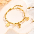 Gold chain bracelet featuring round coins and letter F charm on a white tray - Queen Portrait - Letter F (7848)