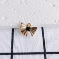 Detail of a gold bow pendant with black gemstone and textured metal for DIY jewelry making - Gold Bow With Black Stone (1#)