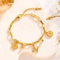 Gold stainless steel chain bracelet featuring letter N, queen coin, and gold bead charms - Queen Portrait - Letter N (7779)