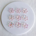 Macro detail of nine translucent aurora acrylic flower charms with iridescent AB coating - 21x6mm / Pink Small