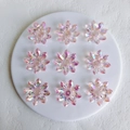 Macro view of clear aurora acrylic flower charms for jewelry making with AB coating effect - Pink Medium