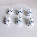 Macro view of blue and white ceramic cat beads for DIY jewelry on a white porcelain plate - Blue and White Pattern (KP5452)