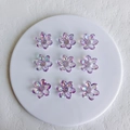 Macro shot of nine translucent iridescent purple acrylic flower beads for DIY jewelry making - 21x6mm / Lilac Small