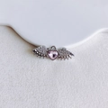 Macro view of a silver wing-shaped pendant with a pink heart gemstone and micro diamonds - Pink Heart Angel Wings (4#)