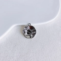 Macro detail of a silver floral relief pendant with elegant scalloped edges on a tray - Silver Floral Relief Style (6#)
