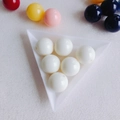 Macro detail of round acrylic colorful candy beads in a white triangular tray for DIY - Milk White (10#)