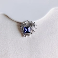 Macro detail of irregular silver heart pendant with square blue zircon on fabric - Silver Deep Blue Gemstone (11#)