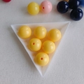 Macro view of bright yellow acrylic round beads with center hole on white tray - Yellow (21#)