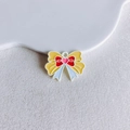 Detailed view of yellow enamel butterfly bow charm with red center and pink heart - Sailor Moon Style Bowknot (29#)