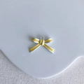 Detailed view of yellow bow-knot alloy pendant on a white ceramic plate for DIY jewelry - Yellow Silver Edge Bow Style (12#)