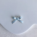 Macro shot of silver bow pendant with light blue enamel and metal ring detail - Blue Silver Edge Bow Style (13#)