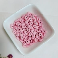 Pink oval beads with high-gloss porcelain finish in a white ceramic bowl for DIY jewelry - Pink